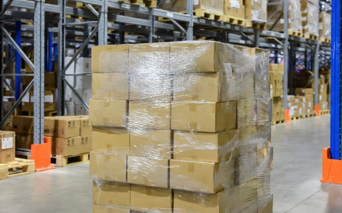Shrink-wrapped standard pallet stored on warehouse racking