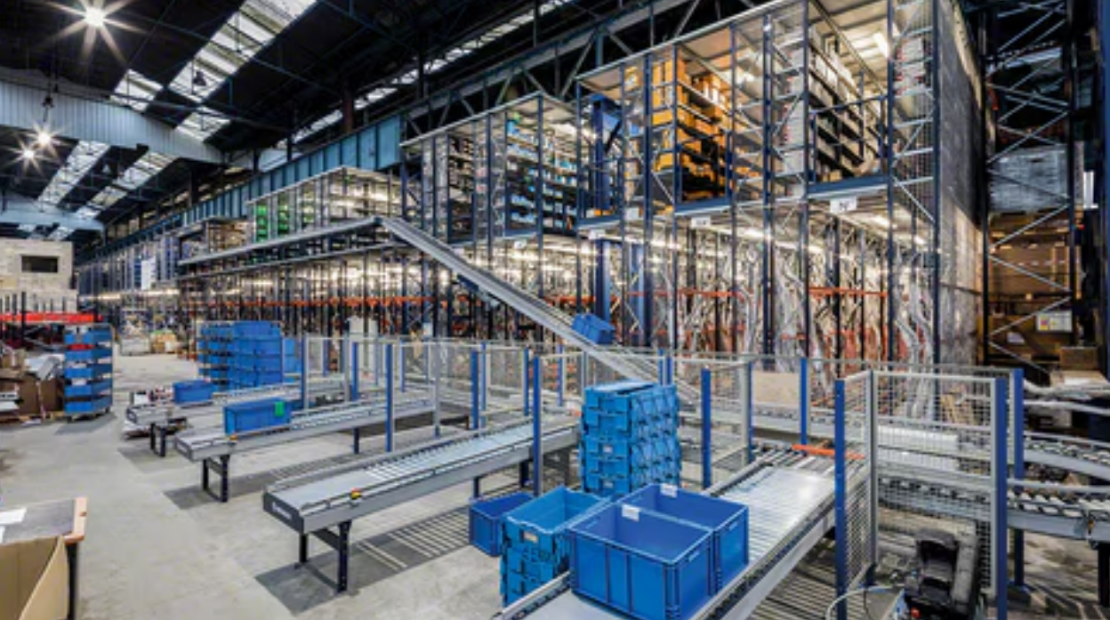 Automated multi-level warehouse pick module with conveyors and tote handling