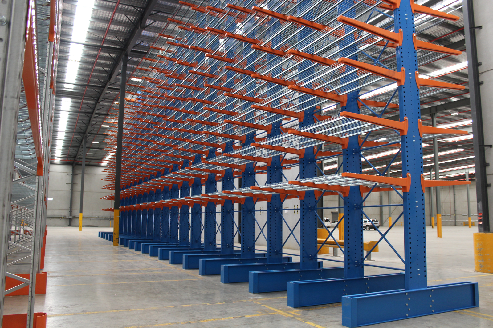 Long rows of empty double-sided cantilever racking in a warehouse