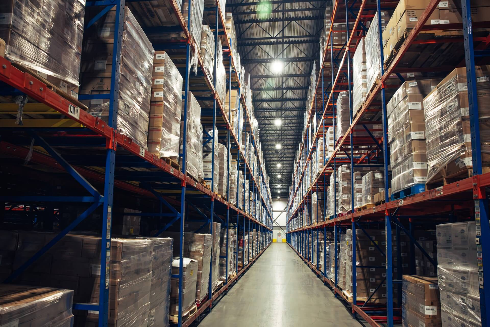 Narrow aisle warehouse pallet racking filled with palletized goods